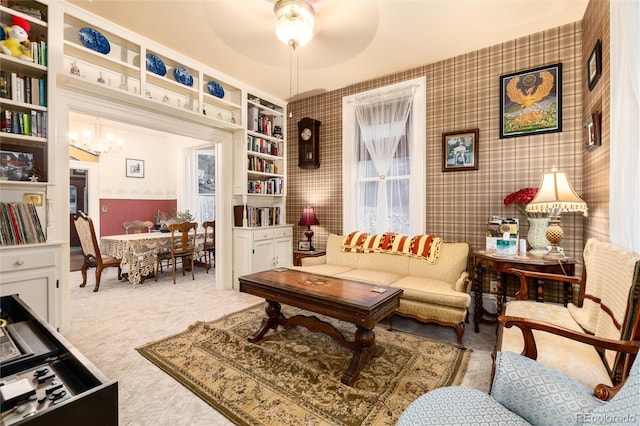 200 Rose St, Georgetown, CO 80444 - carpeted living area with a ceiling fan, a chandelier, built in features, and wallpapered walls