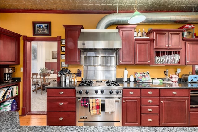 200 Rose St, Georgetown, CO 80444 - kitchen with wall chimney exhaust hood, stainless steel range with gas cooktop, light wood-style floors, and dark brown cabinets