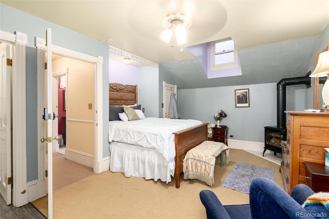 200 Rose St, Georgetown, CO 80444 - carpeted bedroom with vaulted ceiling, a wood stove, and a ceiling fan