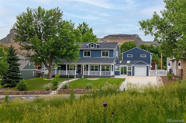 2221 Illinois St, Golden, CO 80401 - view of front of house featuring covered porch, a mountain view, driveway, and a shingled roof