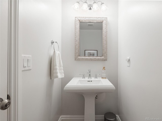 2221 Illinois St, Golden, CO 80401 - bathroom with a chandelier and baseboards