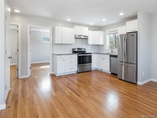 2221 Illinois St, Golden, CO 80401 - kitchen featuring stainless steel appliances, under cabinet range hood, white cabinets, backsplash, and recessed lighting
