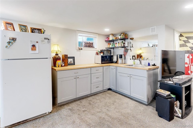 2221 Illinois St, Golden, CO 80401 - kitchen with freestanding refrigerator, black microwave, butcher block counters, light carpet, and open shelves