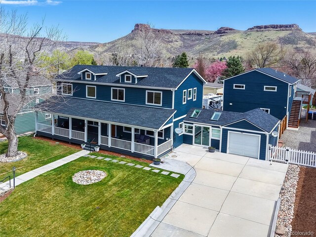 2221 Illinois St, Golden, CO 80401 - view of front facade with concrete driveway, covered porch, a shingled roof, and a mountain view