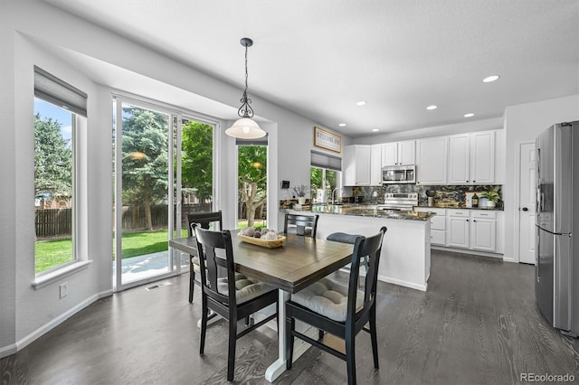 17395 E Dewberry Dr, Parker, CO 80134 - dining space featuring plenty of natural light, baseboards, dark wood finished floors, and recessed lighting