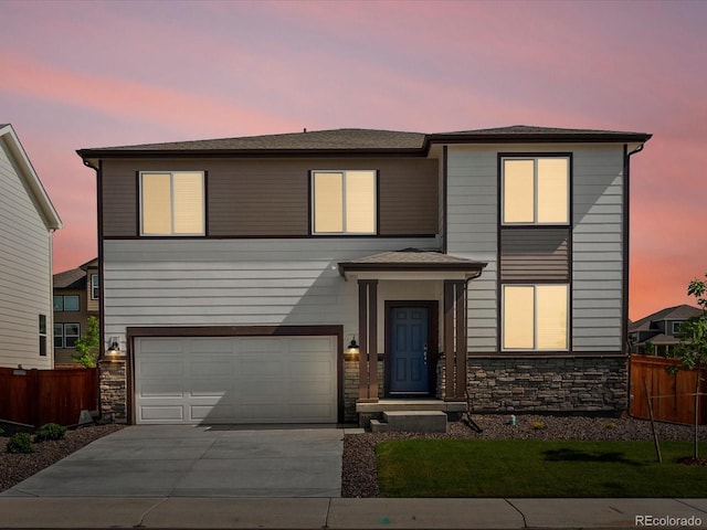1023 Odessa Lake Rd, Severance, CO 80550 - view of front of house featuring stone siding, concrete driveway, and an attached garage