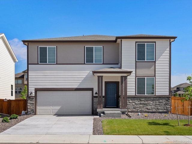 1023 Odessa Lake Rd, Severance, CO 80550 - view of front facade with stone siding, driveway, and an attached garage