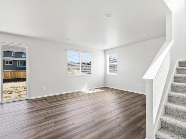 1023 Odessa Lake Rd, Severance, CO 80550 - unfurnished living room with dark wood-style floors and stairway