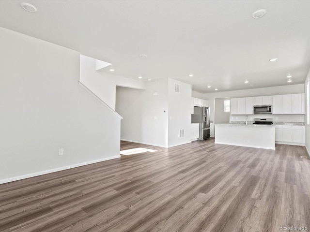 1023 Odessa Lake Rd, Severance, CO 80550 - unfurnished living room featuring light wood-type flooring and recessed lighting