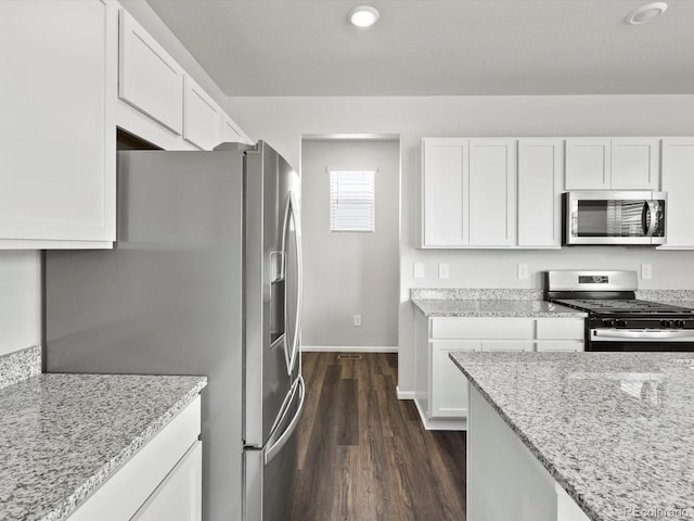 1023 Odessa Lake Rd, Severance, CO 80550 - kitchen with stainless steel appliances, dark wood-style flooring, light stone countertops, white cabinets, and recessed lighting