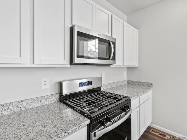 1023 Odessa Lake Rd, Severance, CO 80550 - kitchen with stainless steel appliances and white cabinets