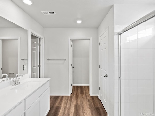 1023 Odessa Lake Rd, Severance, CO 80550 - full bathroom featuring vanity, a stall shower, wood finished floors, and recessed lighting