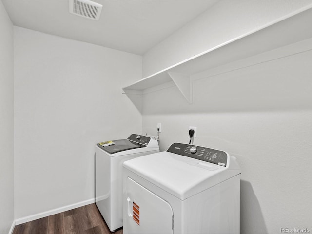 1023 Odessa Lake Rd, Severance, CO 80550 - washroom with washing machine and clothes dryer and dark wood finished floors