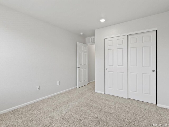 1023 Odessa Lake Rd, Severance, CO 80550 - unfurnished bedroom featuring light colored carpet, a closet, and recessed lighting