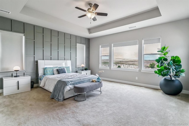 8299 S Kellerman, Aurora, CO 80016 - bedroom with a tray ceiling, light carpet, baseboards, and a ceiling fan