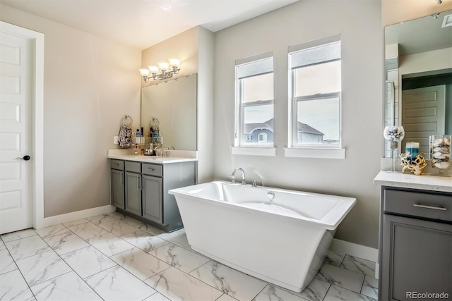 8299 S Kellerman, Aurora, CO 80016 - full bathroom with baseboards, marble look tile flooring, vanity, and a freestanding bath