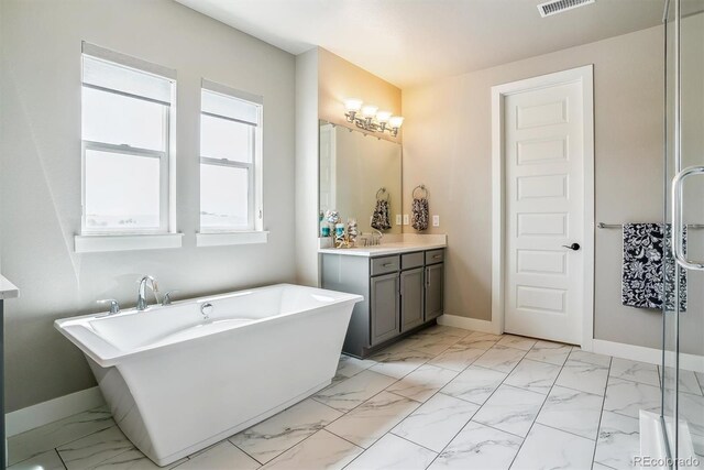 8299 S Kellerman, Aurora, CO 80016 - full bathroom featuring marble look tiles, baseboards, vanity, and a freestanding tub