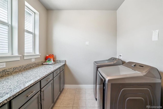 8299 S Kellerman, Aurora, CO 80016 - washroom featuring washing machine and clothes dryer, baseboards, cabinet space, and light tile patterned flooring