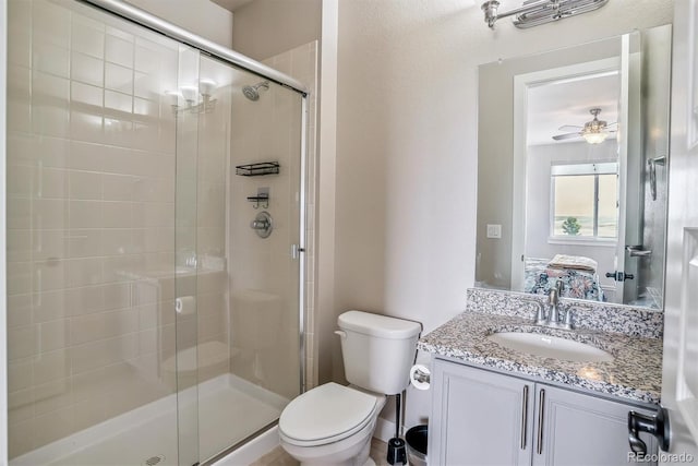 8299 S Kellerman, Aurora, CO 80016 - bathroom featuring toilet, a shower stall, vanity, and ceiling fan