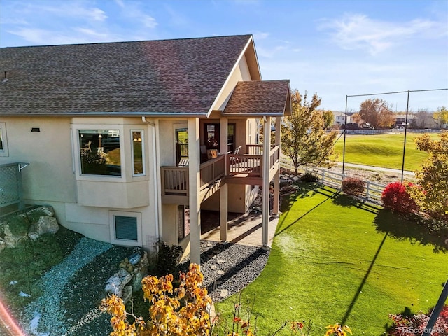 1743 Homestead Dr, Fort Lupton, CO 80621 - rear view of property with a shingled roof and stucco siding