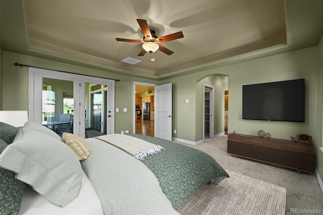 1743 Homestead Dr, Fort Lupton, CO 80621 - bedroom with a raised ceiling, carpet, arched walkways, freestanding refrigerator, and baseboards