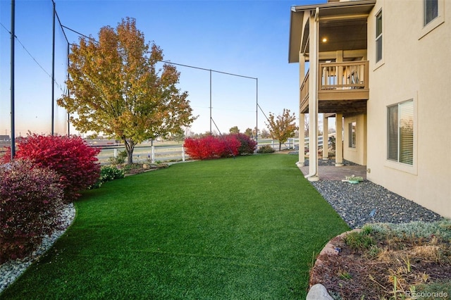1743 Homestead Dr, Fort Lupton, CO 80621 - view of grassy yard featuring a balcony and a patio