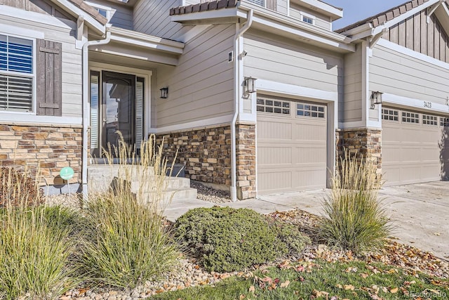 3423 Princeton Pl, Broomfield, CO 80023 - doorway to property featuring stone siding, an attached garage, and driveway