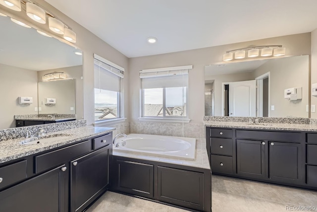 bathroom with vanity, tile patterned floors, and plus walk in shower