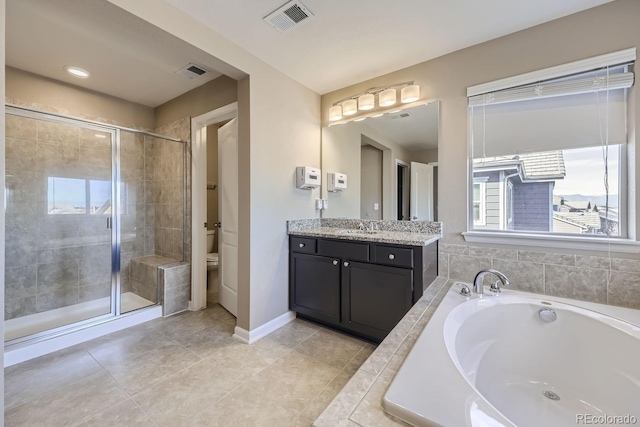3423 Princeton Pl, Broomfield, CO 80023 - bathroom with a shower stall, tile patterned floors, a garden tub, vanity, and baseboards