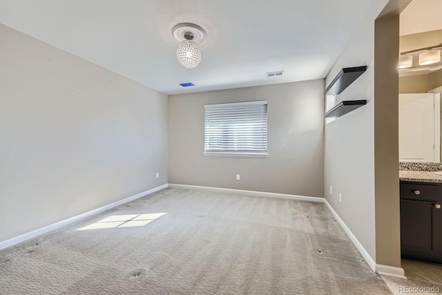 empty room featuring light colored carpet