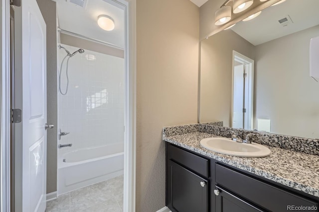 bathroom featuring vanity, tiled shower / bath combo, and tile patterned floors