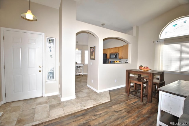 foyer entrance featuring hardwood / wood-style flooring and lofted ceiling