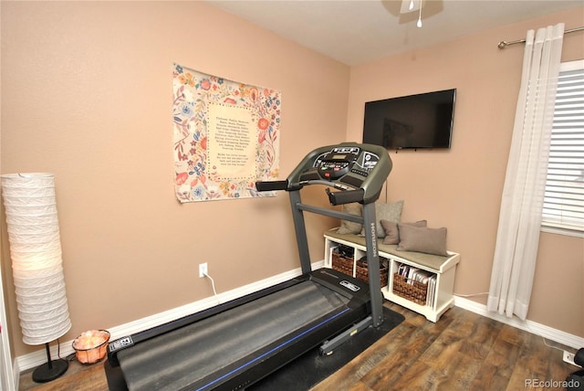 workout area with dark wood-type flooring