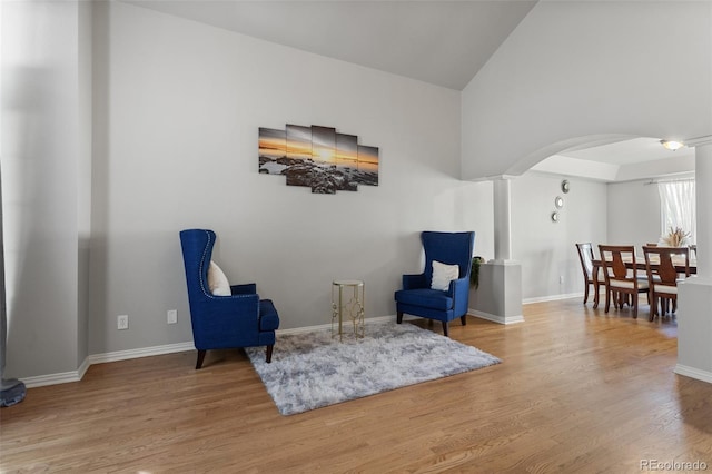 2211 S Moline Ct, Aurora, CO 80014 - sitting room with arched walkways, wood finished floors, and high vaulted ceiling