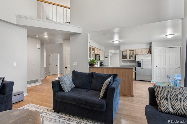 2211 S Moline Ct, Aurora, CO 80014 - living area with light wood finished floors and a towering ceiling