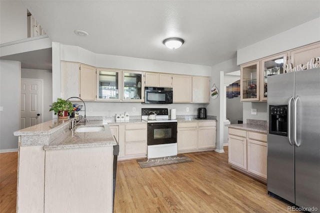 2211 S Moline Ct, Aurora, CO 80014 - kitchen with stainless steel fridge, black microwave, range with electric cooktop, a peninsula, and glass insert cabinets