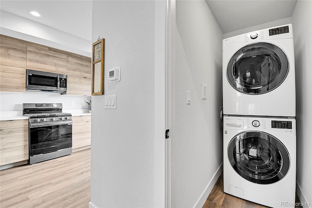 3458 W 63rd Ave, Denver, CO 80221 - washroom featuring stacked washer / dryer, light wood-type flooring, and recessed lighting
