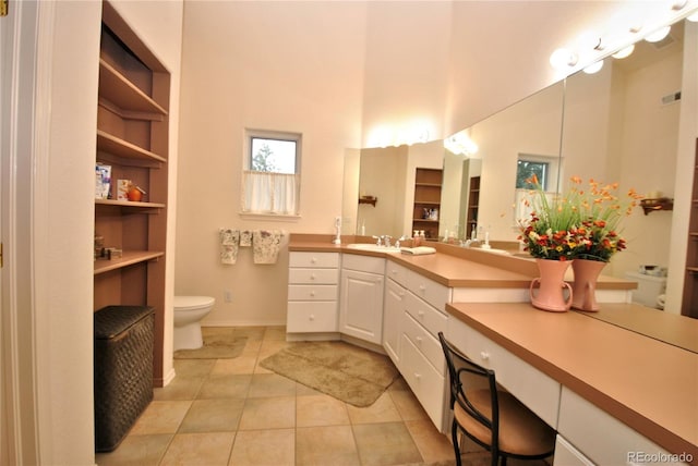 319 Summit Rd, Woodland Park, CO 80863 - bathroom with a towering ceiling, toilet, vanity, tile patterned floors, and baseboards