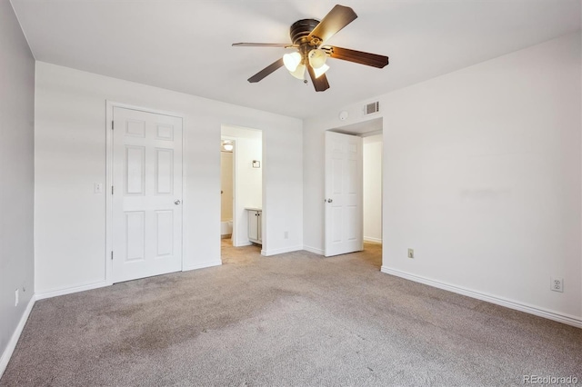 3141 S Tamarac Dr Unit 206E, Denver, CO 80231 - unfurnished bedroom with light carpet, connected bathroom, and ceiling fan