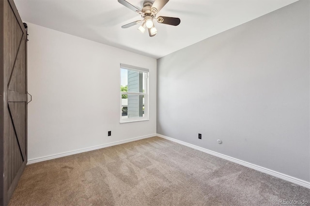 3141 S Tamarac Dr Unit 206E, Denver, CO 80231 - empty room featuring carpet floors, a barn door, and a ceiling fan