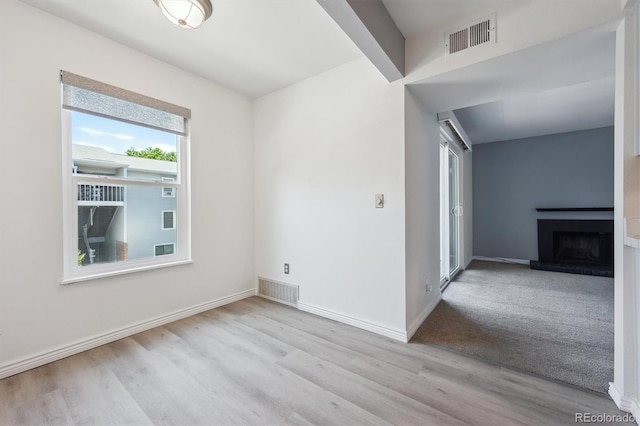 3141 S Tamarac Dr Unit 206E, Denver, CO 80231 - spare room with wood finished floors and a fireplace with raised hearth