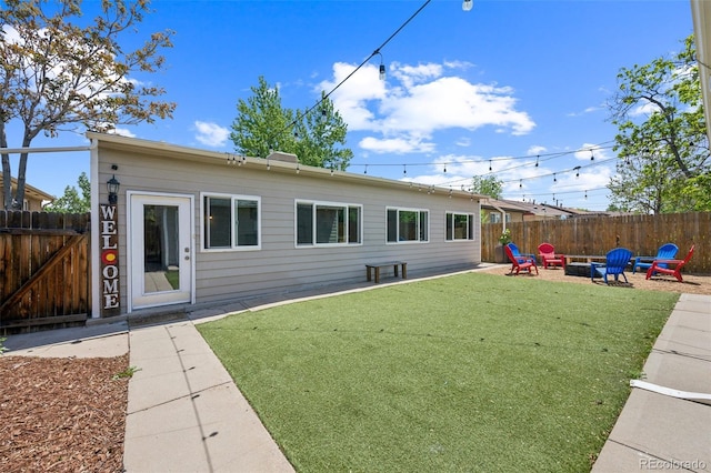 3241 Sheridan Blvd, Wheat Ridge, CO 80212 - rear view of house featuring an outdoor fire pit