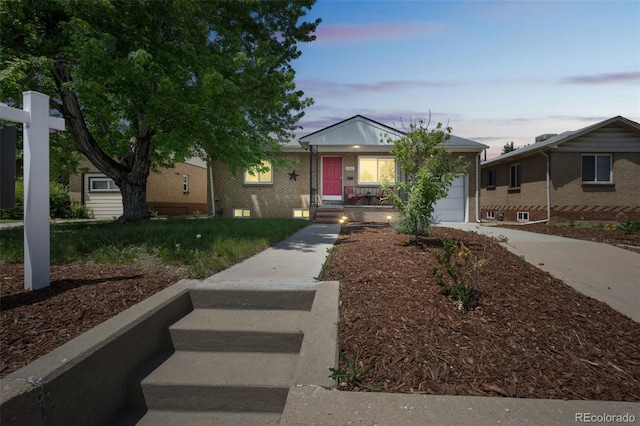 3241 Sheridan Blvd, Wheat Ridge, CO 80212 - view of front of home featuring a garage and concrete driveway