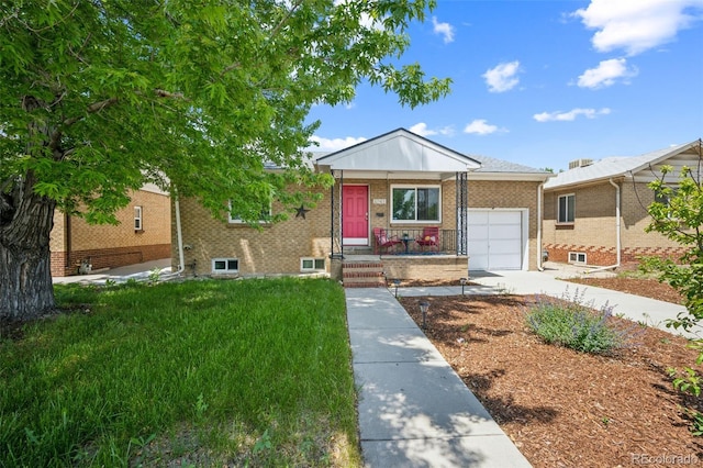 3241 Sheridan Blvd, Wheat Ridge, CO 80212 - view of front of home featuring a garage, brick siding, and driveway