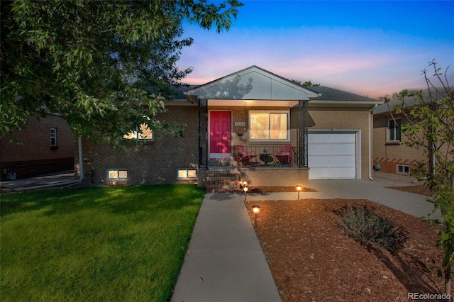3241 Sheridan Blvd, Wheat Ridge, CO 80212 - ranch-style house featuring a garage, brick siding, a lawn, a porch, and driveway