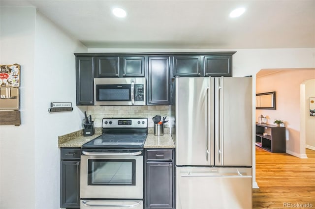 3241 Sheridan Blvd, Wheat Ridge, CO 80212 - kitchen with appliances with stainless steel finishes, light stone countertops, light wood finished floors, tasteful backsplash, and recessed lighting