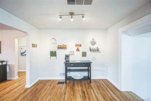 3241 Sheridan Blvd, Wheat Ridge, CO 80212 - bar area featuring arched walkways, wood finished floors, and baseboards