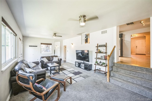 3241 Sheridan Blvd, Wheat Ridge, CO 80212 - living area featuring light colored carpet, a ceiling fan, and baseboards