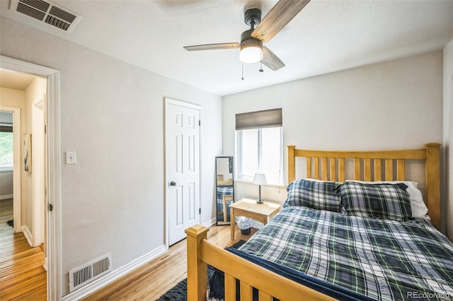 3241 Sheridan Blvd, Wheat Ridge, CO 80212 - bedroom featuring wood finished floors, baseboards, a ceiling fan, and a textured wall