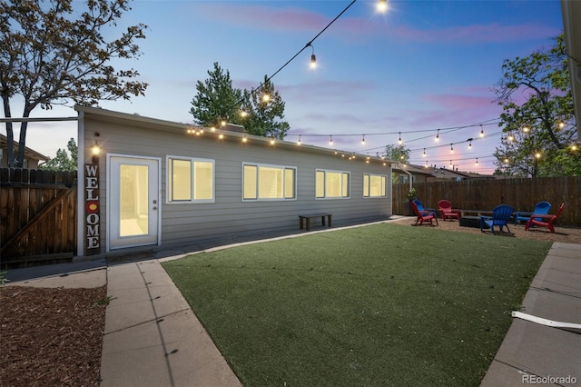 3241 Sheridan Blvd, Wheat Ridge, CO 80212 - back of property at dusk with an outdoor fire pit